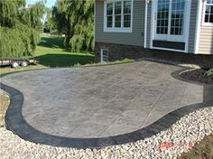 a concrete patio in front of a house