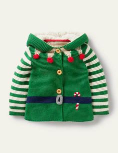 a green and white sweater with candy canes on it