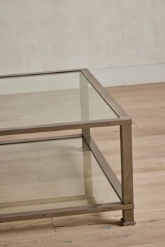 a glass table sitting on top of a hard wood floor