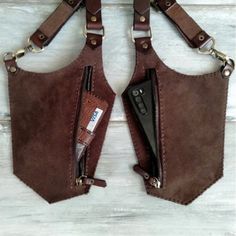 two pieces of brown leather with zippers on them