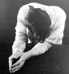 a black and white photo of a person with their hands on the ground in front of him