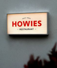 a restaurant sign mounted to the side of a building