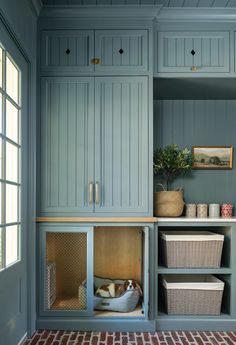 a room with blue walls and shelves filled with baskets