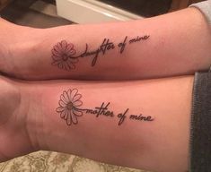 two people with matching tattoos on their arms that say, daughter of mine and mother of me