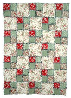 a red and green patchwork quilt on a white background