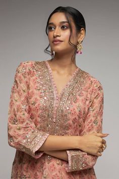 Blush pink kurta with bouquet print all over and sequin, gold thread embroidery. Paired with dhoti pant.
Components:2
Pattern:Printed, Embroidery
Type of Work:Bouquet, sequin, thread
Neckline:V neck
Sleeve Type:Three quarter
Fabric:Kurta: Georgette, Dhoti Pant: Cotton
Color:Pink
Other Details:
Cutwork border
Lace embroidered border
Occasion:Sangeet - Aza Fashions Gopi Vaid, Blouse Yoke, Pink Kurta, Printed Embroidery, Border Lace, Dhoti Pants, Kurta Dress, Embroidered Border, Embroidery Neck Designs