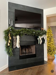 a fireplace decorated for christmas with stockings and stockings hanging from the mantle