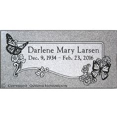 a memorial plaque with butterflies on it