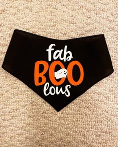 a black dog bandana with the words fab booous printed on it's side