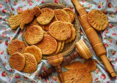 a basket filled with cookies next to a rolling pin