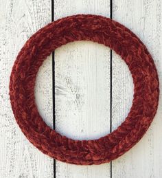 a red rope hanging on the side of a white wooden wall next to a door