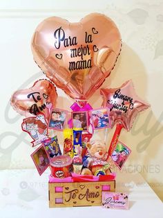 a box filled with pink balloons and pictures