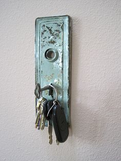 a bunch of keys that are on a doorknob attached to a wall with a key chain