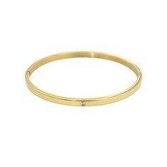 The ONE SHINY BANGLE, which is a single, minimalist gold bracelet, features a sleek design with a single sparkling crystal accent. This elegant bangle is perfect for everyday wear or layering with other bracelets for a sophisticated look. Gold Stainless Steel Jewelry With Diamond Accents, Tarnish-resistant Stainless Steel Gold Bracelet, Everyday Round Stainless Steel Bangle, Everyday Stainless Steel Round Bangle, Minimalist Gold Bangle With Diamond Accents, 18k Gold, Gold Tones, Gold Plate, Bangles