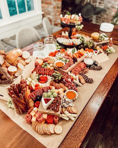 a wooden table topped with lots of different types of food