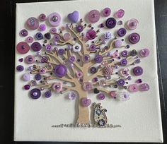 a tree made out of buttons on top of a piece of paper with an owl sitting under it