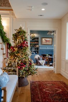 a living room with a christmas tree in the corner