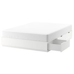 a white bed with two drawers underneath it