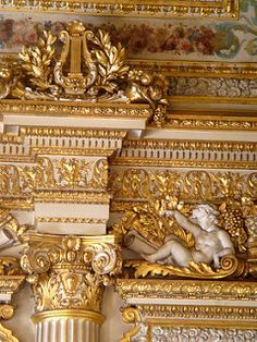 ornate gold and white decorations on the ceiling