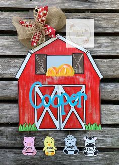 a red barn with three farm animals on it