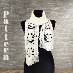 a white crocheted scarf on a mannequin