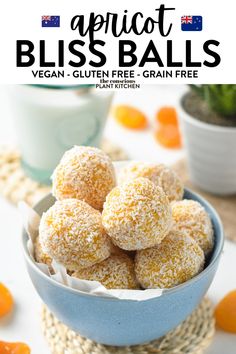 a bowl filled with orange bliss balls on top of a table