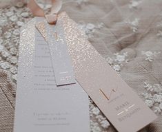 two tags attached to the side of a wedding dress