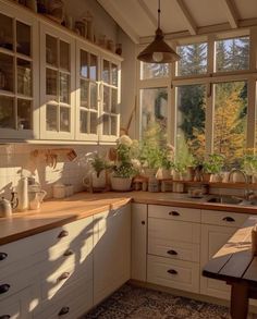 a kitchen filled with lots of pots and pans on top of a wooden counter