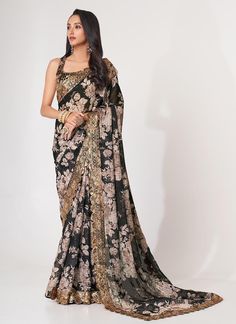 Introducing our latest creation, a luxurious black premium floral printed organza party wear saree. Complete with a beautiful blouse, this saree is the perfect addition to your wardrobe for any festive or reception occasion. Be the center of attention and make a statement with this exclusive saree. The perfect gift for her. The unstitched blouse can be customized upto 42 inches. Do Note: All the accessories shown are for styling purpose only. Slight color variation may occur due to photographic Black Organza Saree, Sequins Saree, Printed Organza, Floral Print Sarees, Organza Blouse, Black Saree, Sequence Work, Printed Saree, Wear Saree