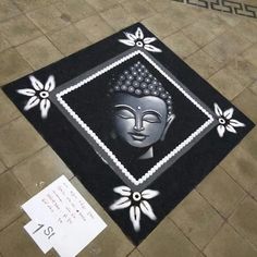 a black and white rug with a buddha face on it in the middle of a tile floor