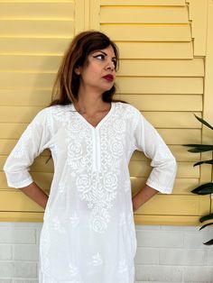 Introducing our White Women's Chikankari Kurta Long, a stunning fusion of style and comfort designed for warm weather elegance. This airy and lightweight Indian cotton white kaftan dress is your perfect companion on scorching summer days. What's more, the softness of this cotton kurta only deepens with each wash, ensuring a delightful wearing experience. This hand-embroidered beauty isn't just a piece of clothing; it's an ideal choice for functions and parties. Whether you're aiming for a classi White V-neck Kaftan For Spring, Flowy White Top For Beach Cover-up, White Long Tunic For Spring, Off White Summer Dress With Chikankari Embroidery, White Relaxed Fit Tunic Dress, Casual White Long Sleeve Kaftan, Off White Chikankari Embroidery Dress For Summer, White Summer Tunic Kaftan, White Tunic Kaftan For Summer