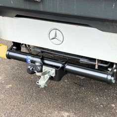 the front end of a car with a mercedes logo on it's bumper guard