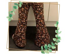 a pair of high heeled shoes sitting on top of a floor next to a plant