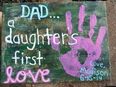 a sign that says, dad a daughter's first love with handprints on it