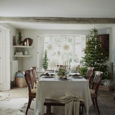 a dining room table is set for christmas dinner