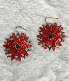 These hand-beaded Poinsettia earrings pop with green accents and a Swarovski crystal center. Created from glass Delica beads, Fireline and sterling French hooks and Swarovski crystals. Get your holiday started in style. Beaded Poinsettia, Poinsettia Earrings, Sequin Jewelry, Holiday Earring, Beaded Ornaments, Delica Beads, Green Earrings, Green Accents, Christmas Earrings