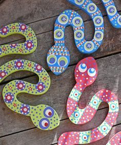 colorful painted wooden letters sitting on top of a wooden table