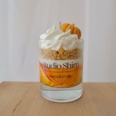 a glass jar filled with food sitting on top of a wooden table