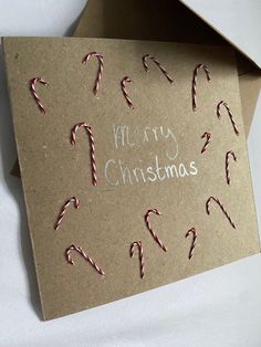 a christmas card with candy canes on it