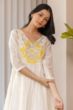 Off-white chanderi anarkali with yellow applique embroidered floral motifs on yoke. Paired with pleated pant and inner.
Component: 3
Pattern: Embroidery
Type Of Work: Floral
Neckline: V neck
Sleeve Type: Three quarter
Fabric: Chanderi, cotton
Color: White
Other Details: 
Bead sleeve hem
Occasion: Puja - Aza Fashions White Anarkali Dress With Embroidered Border, Summer White Embroidered Anarkali Set, Summer Embroidered White Anarkali Set, White Floral Embroidered Dress For Diwali, White Anarkali Set With Floral Embroidery For Summer, White Floral Embroidery Anarkali Set For Summer, White Anarkali Set For Summer, Yellow Cotton Anarkali Set With Floral Embroidery, White Straight Kurta Dress With Embroidered Border