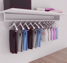 there is a white shelf with clothes hanging on it