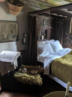 an old fashioned bedroom with two beds and pictures on the wall