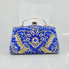 Every aspect of this clutch has been intricately designed to captivate attention and evoke admiration. Its distinctive design distinguishes it, rendering it the ideal accessory to enhance any evening ensemble. Despite its compact size, this clutch boasts surprising spaciousness, effortlessly accommodating all your necessities. Everything finds its place within this compact yet versatile bag! Exclusively available in blue. Chic Rectangular Cosmetic Bag For Party, Elegant Rectangular Pouch With Detachable Handle, Elegant Blue Box Bag As Gift, Chic Evening Pouch Cosmetic Bag, Elegant Blue Box Bag Perfect As A Gift, Elegant Blue Box Bag Perfect For Gifts, Elegant Party Pouch With Detachable Handle, Chic Evening Cosmetic Pouch Bag, Elegant Rectangular Cosmetic Bag With Detachable Handle