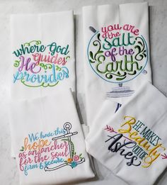 three embroidered tea towels with sayings on them sitting on a counter top next to each other