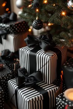 black and white wrapped presents under a christmas tree