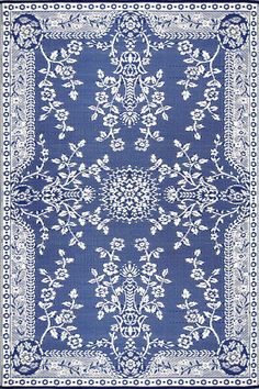 a blue and white rug with an intricate design