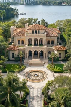 this is an aerial view of a mansion in the middle of palm trees and water