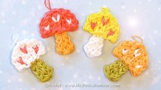 four crocheted mushrooms sitting on top of a table