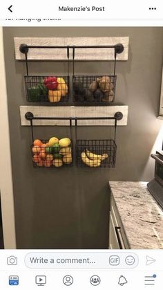 the kitchen is decorated in gray and white with hanging baskets filled with fruit on it