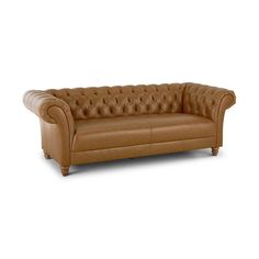 a brown leather couch sitting on top of a white floor